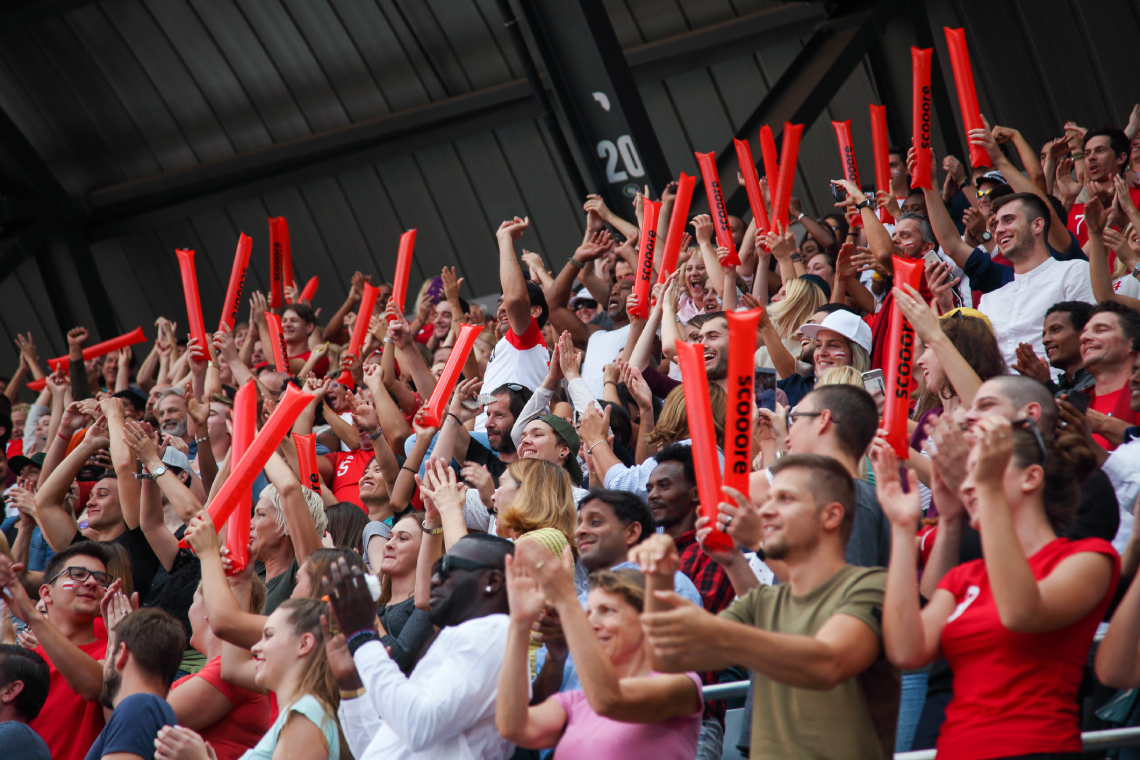 People cheering and clapping on a sports event
