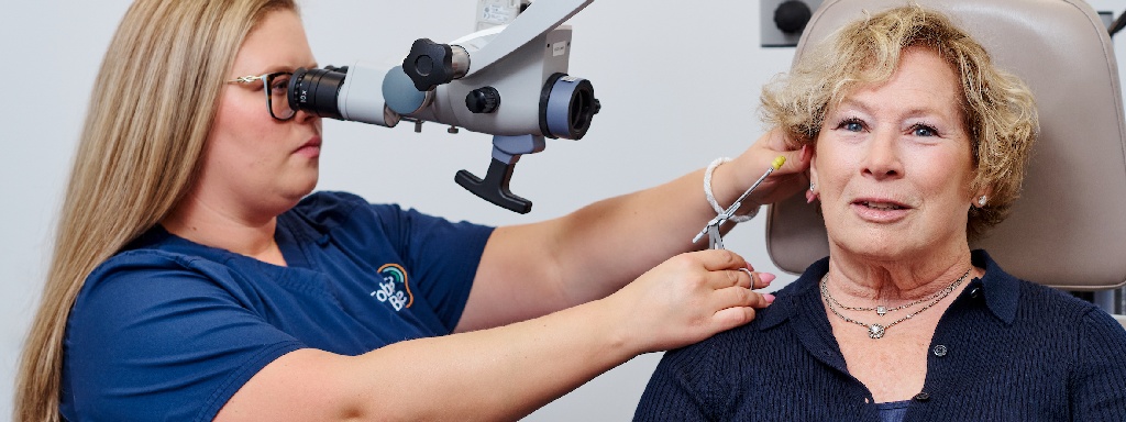 Audiologist checking patient